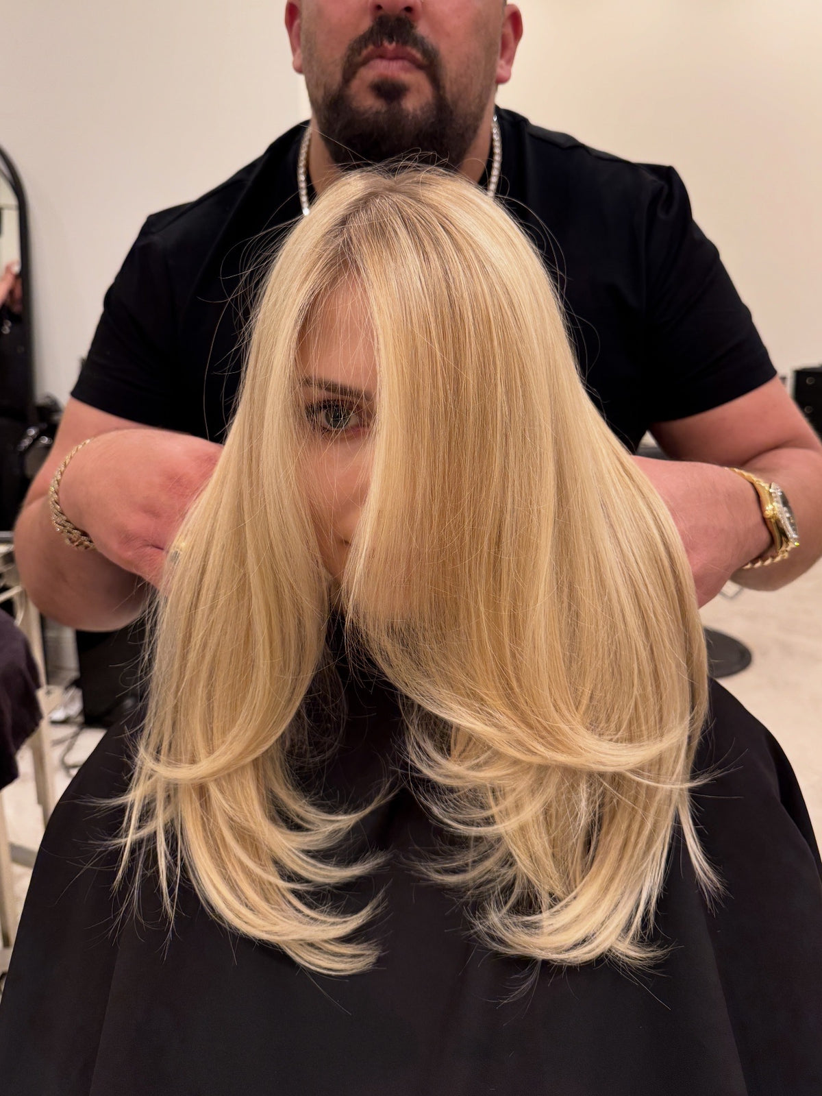 Shak finishing a long platinum blonde blowout