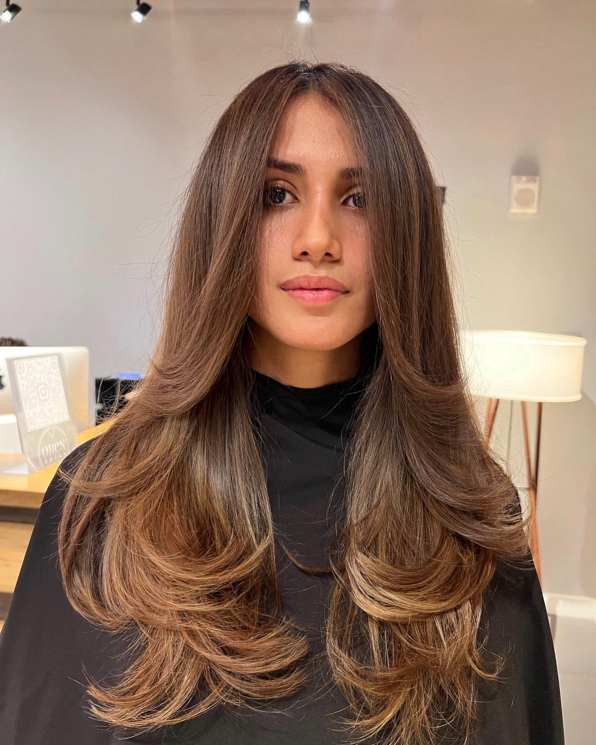 Long brunette layers with caramel balayage on the ends