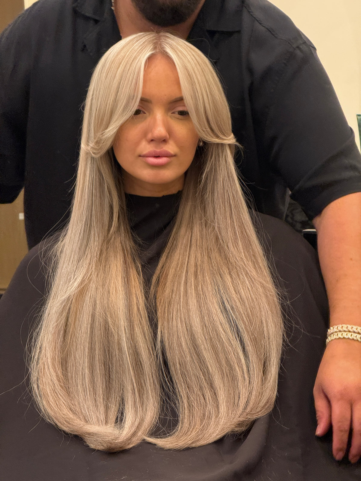 Long blonde hair extensions with curtain bangs