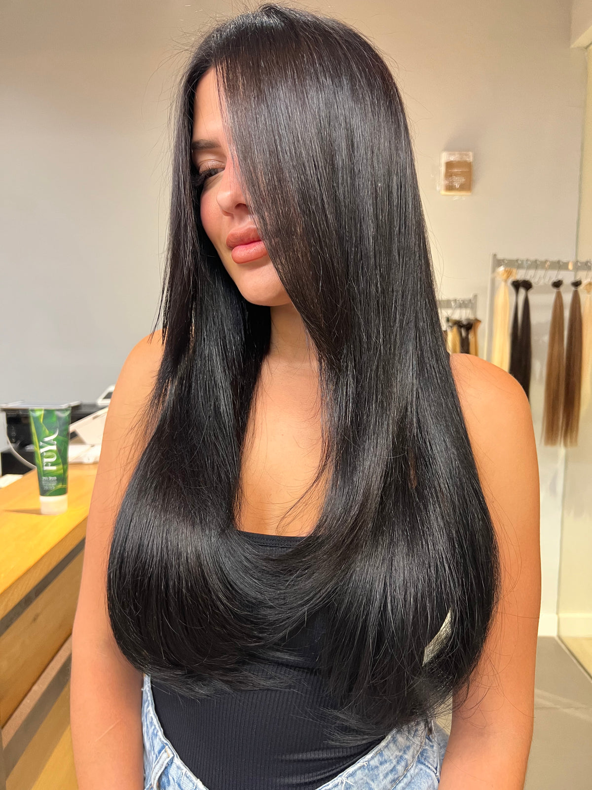 Long, sleek black hair with a side part