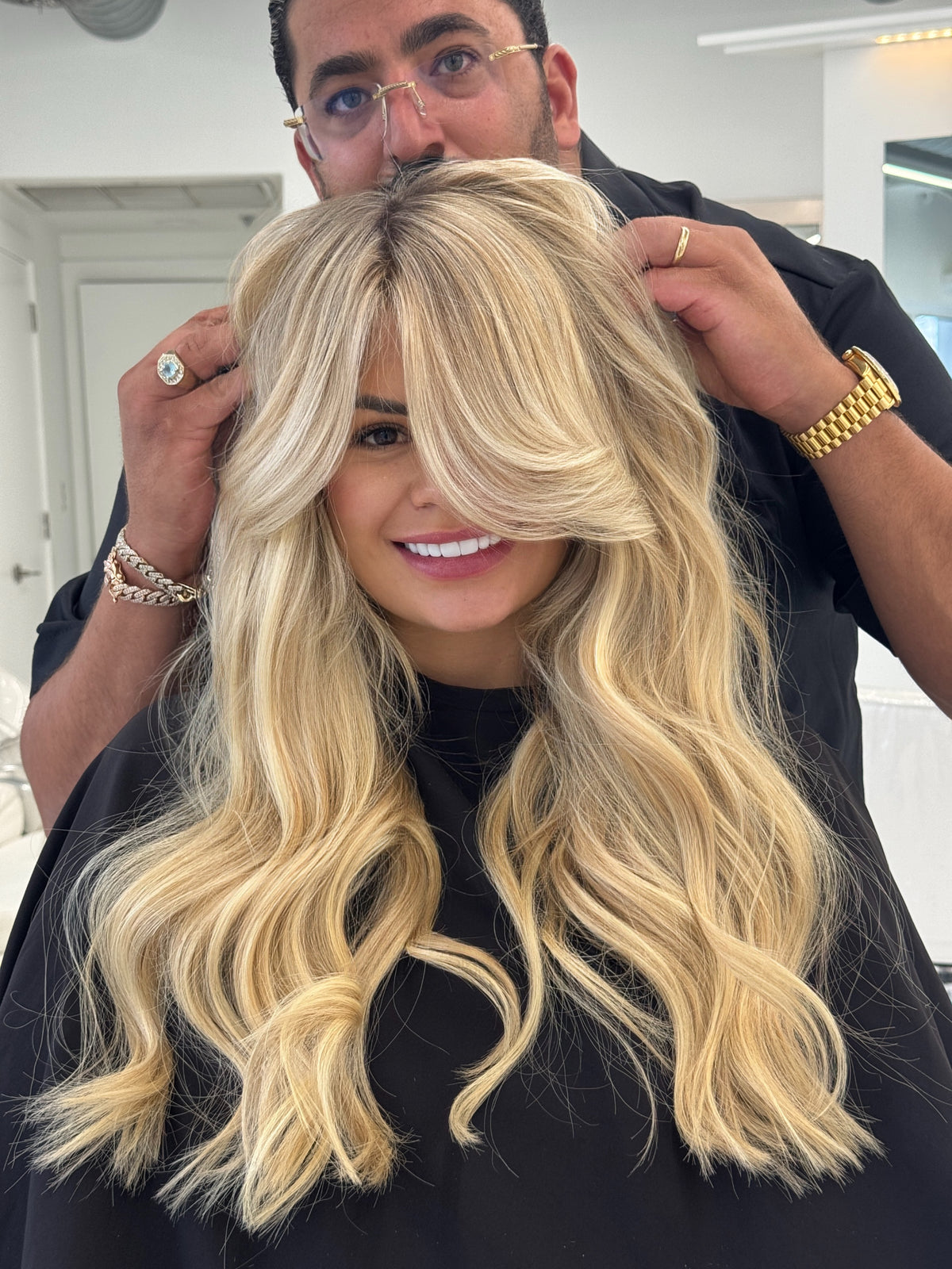 Long platinum blonde waves with extensions, styled by Shak