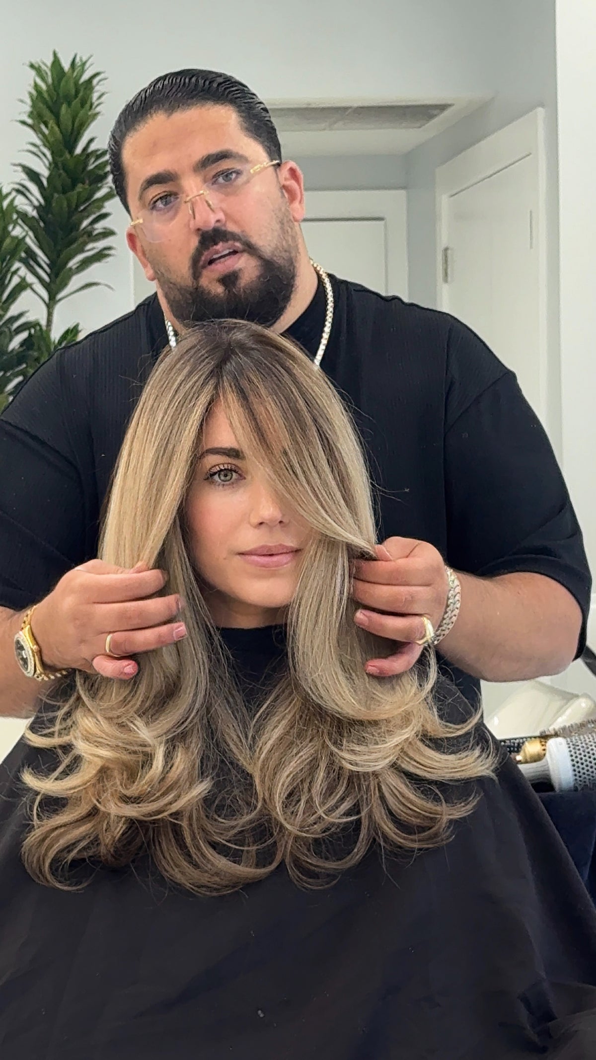 Shak showing a client's blonde balayage with highlights
